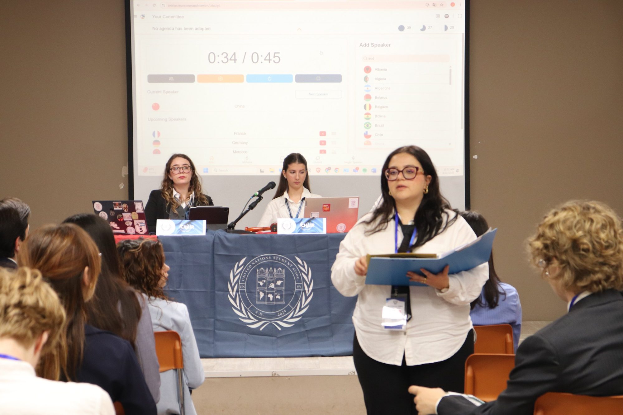 Speakers at the desk during a UNSA event